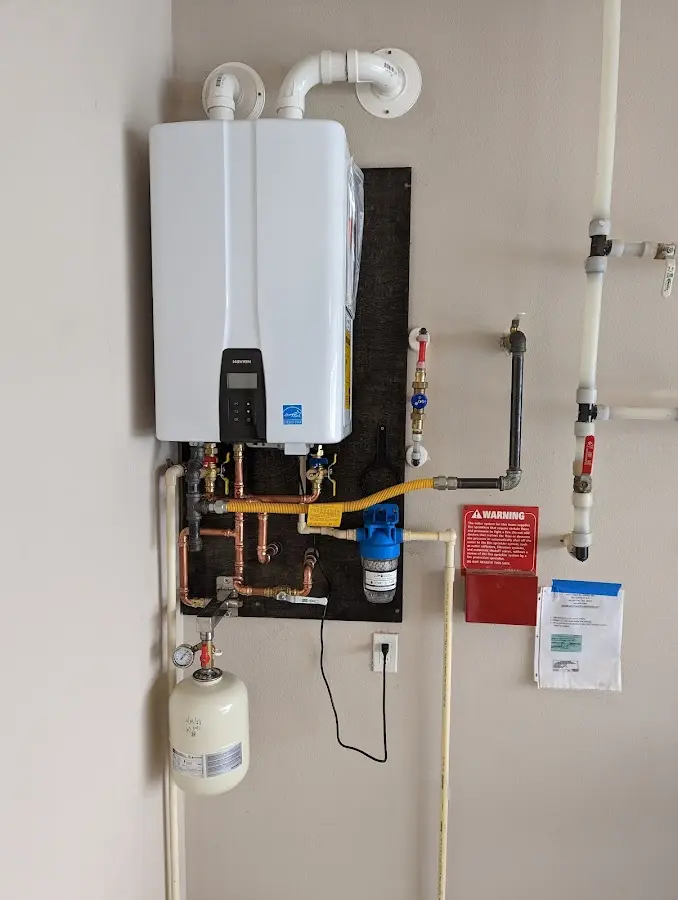 Professional plumber installing copper piping in a Ferguson home